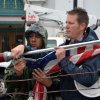 Kyle Reed helps to attach flag to the annual Christmas tree.